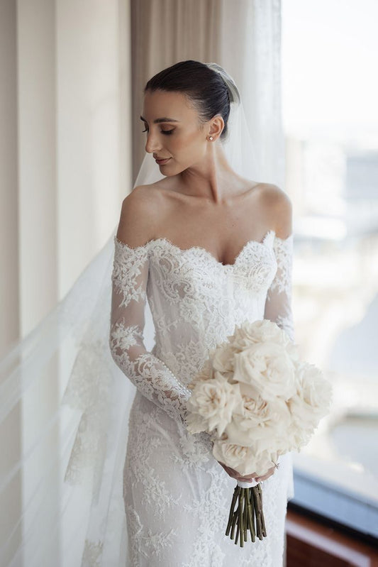 Petite bride in custom wedding dress smiling