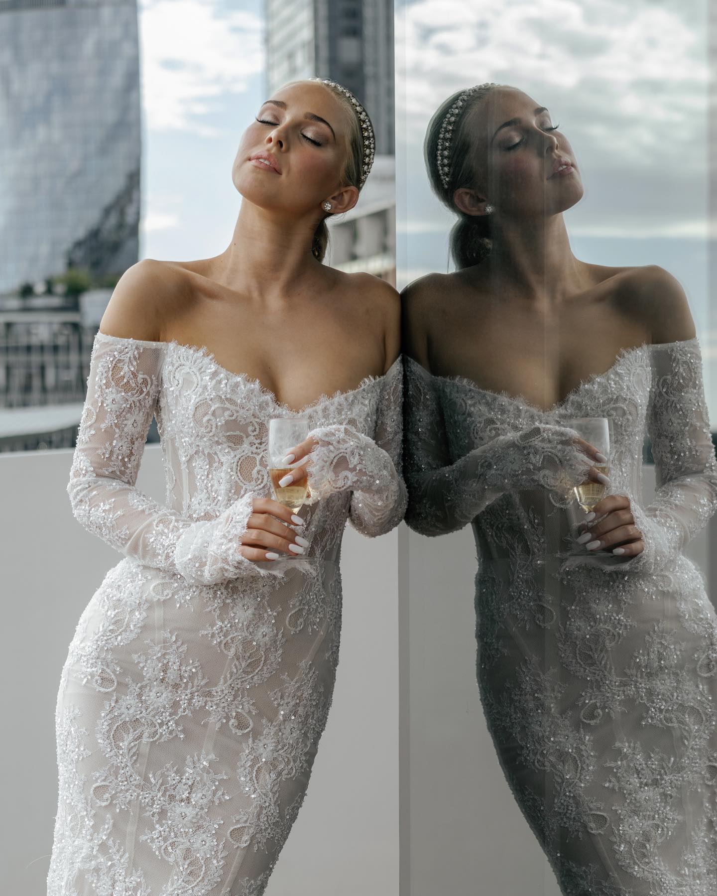 Backless mermaid wedding gown with fitted lace bodice and dramatic sheer arm coverage.
