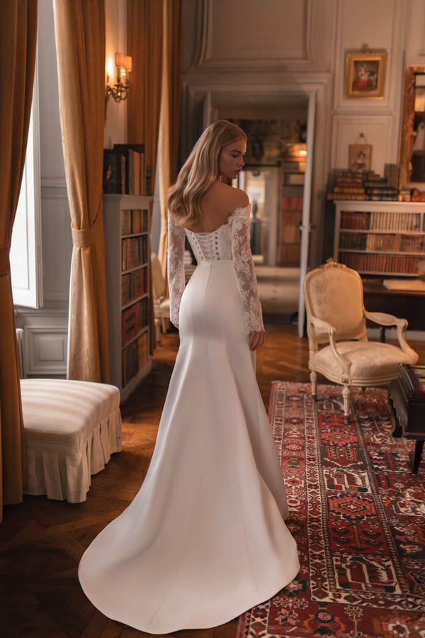 Classic wedding dress featuring romantic lace sleeves and dramatic train for a grand bridal entrance.