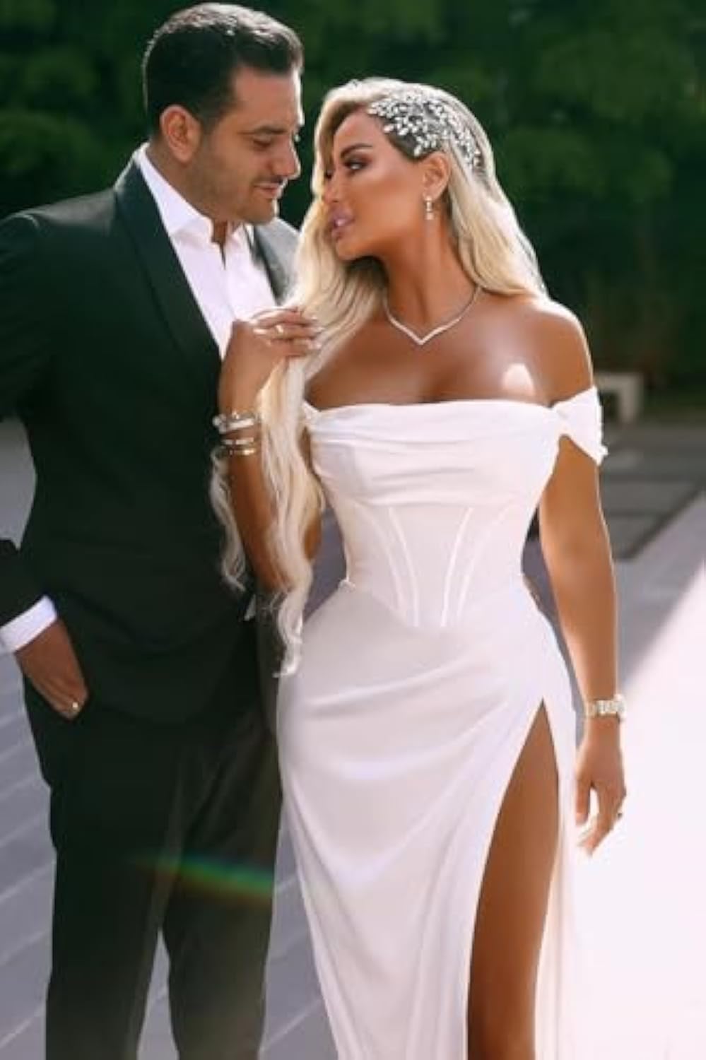 Glamorous wedding gown with sensual high slit and off-shoulder pleated neckline for bold brides.