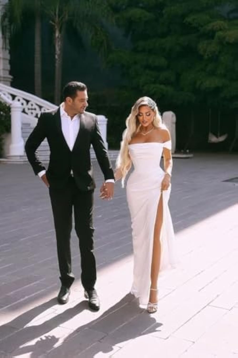Modern mermaid wedding dress with sweep train and fitted shape, ideal for contemporary bridal looks.