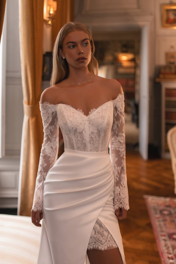 Off-shoulder wedding dress with corset back and elegant lace detail that enhances the waist beautifully.
