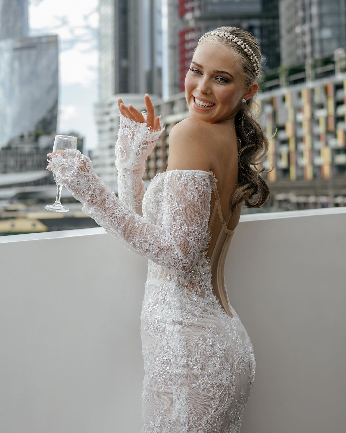 Sheer lace wedding dress with floral embroidery and delicate beading throughout the silhouette.