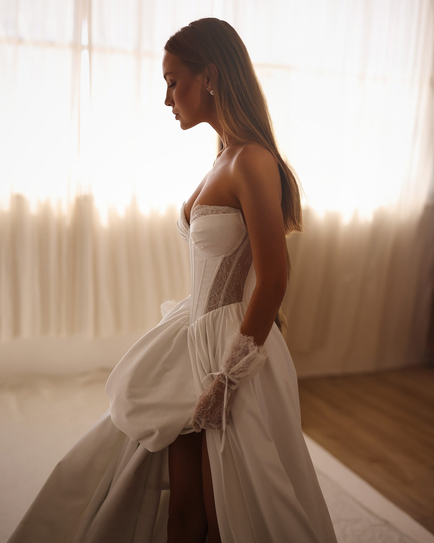 Modern A-line bridal gown perfect for beach weddings with dramatic slit