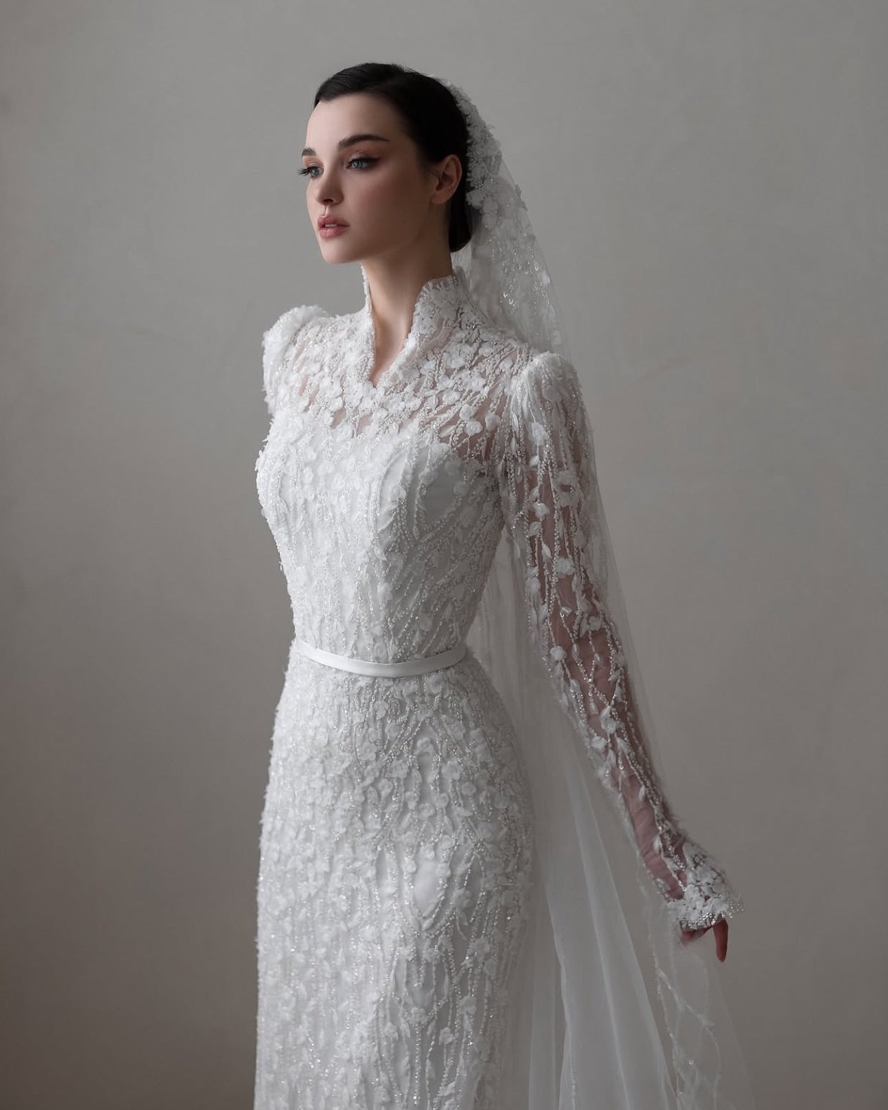 Timeless wedding dress design with high neckline and beaded lace