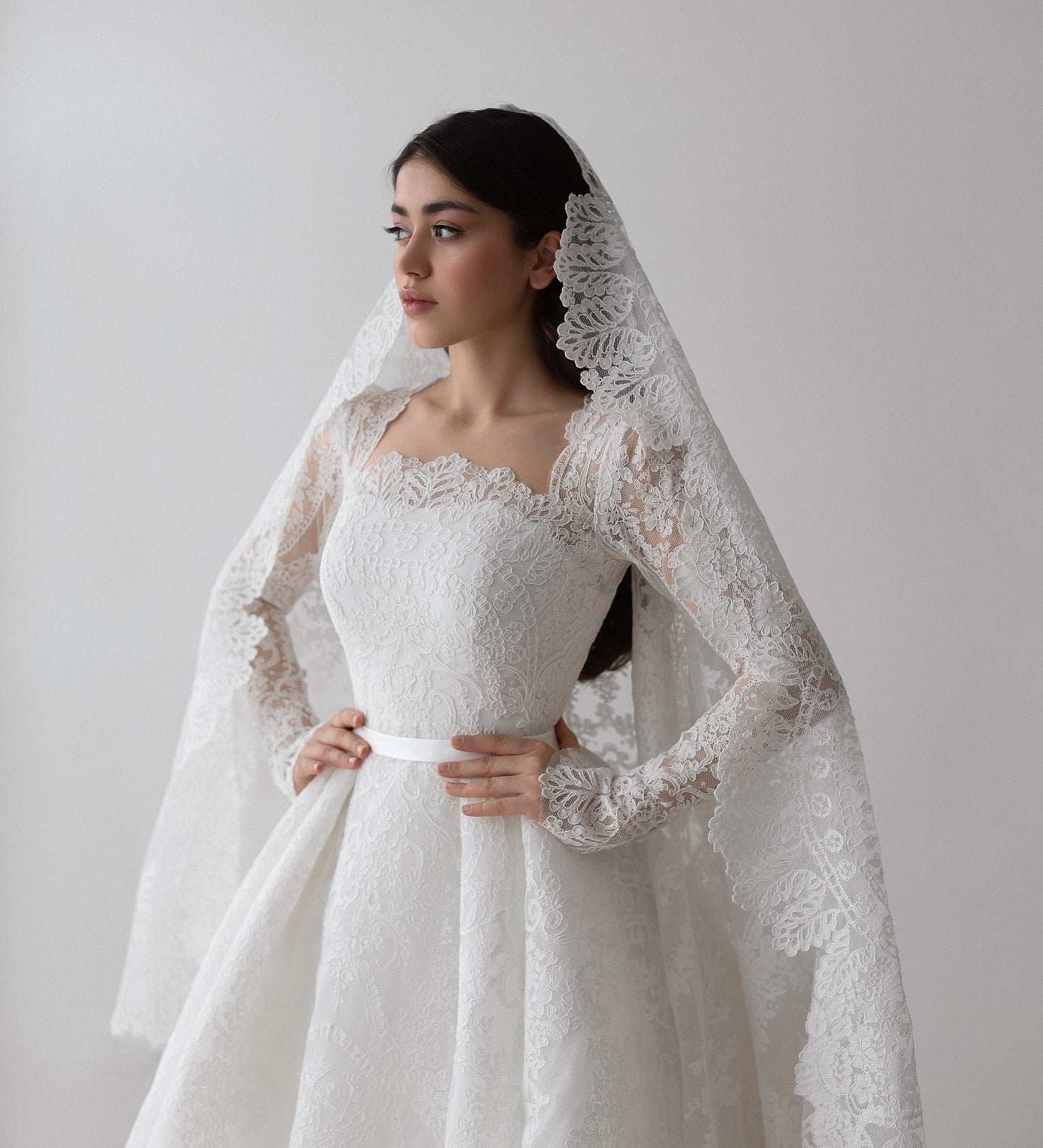 Custom lace wedding dress with chapel-length train and classic princess cut