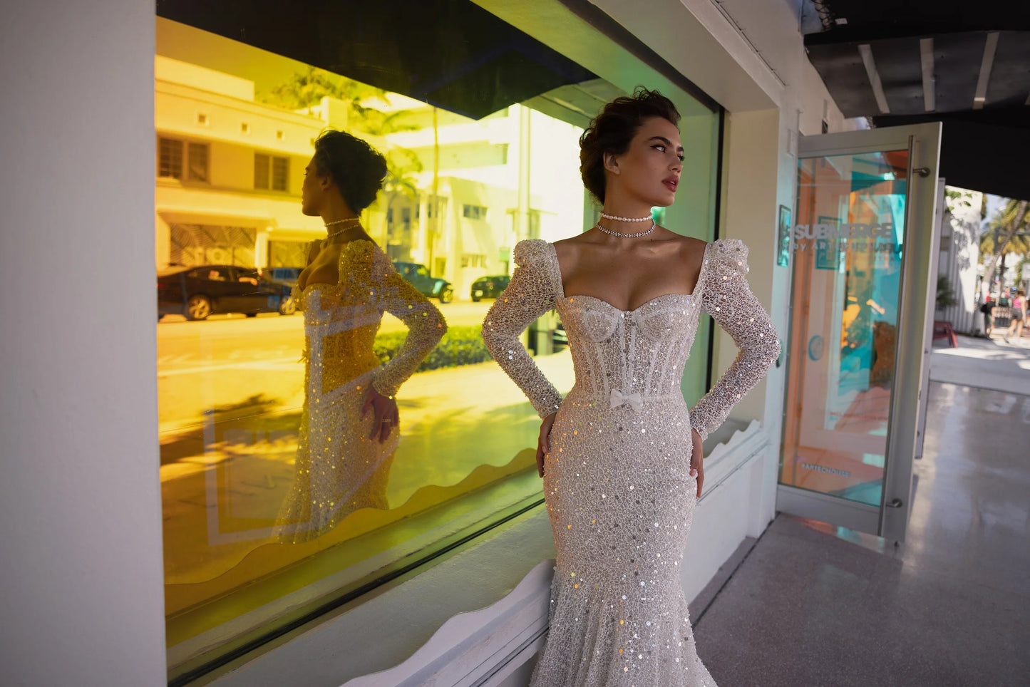 Side and back view showing flattering fit and long shimmering sweep train for red-carpet bridal look.
