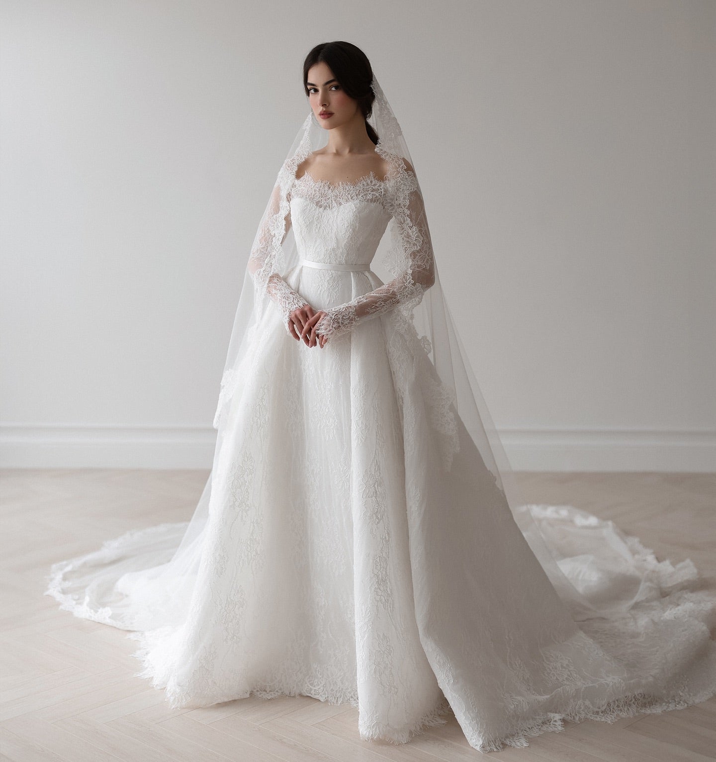Custom-made bridal gown with floral lace details and soft flowing train