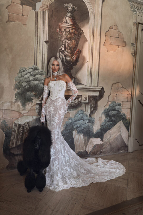 Mermaid silhouette bridal dress with floor-length train and see-through lace details.
