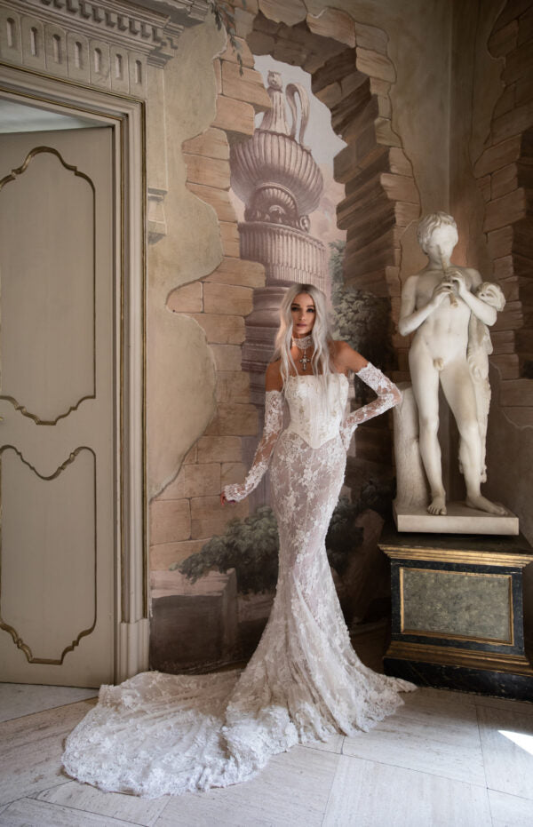Bridal gown with detachable lace sleeves and sheer applique details, offering dual styling options.