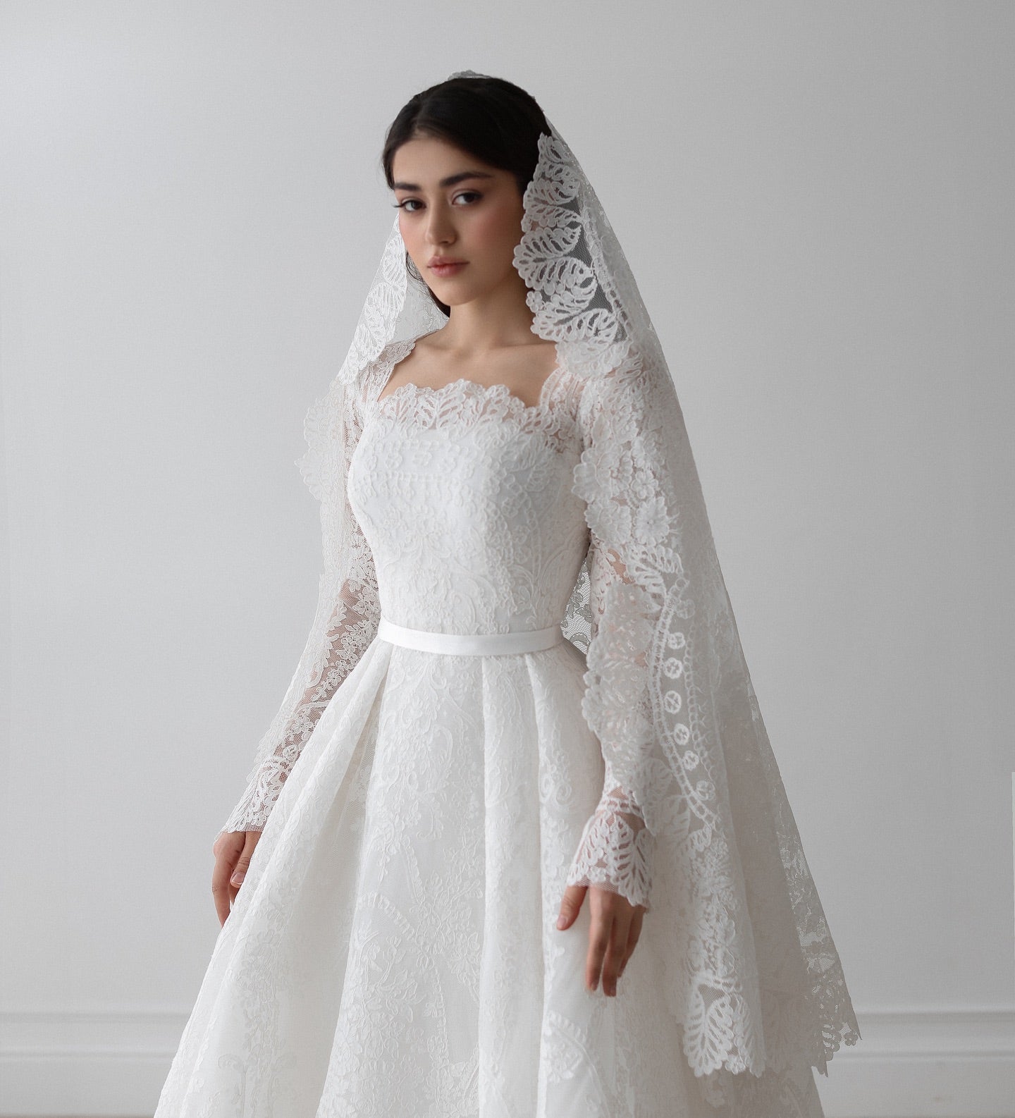 Bridal gown with fitted lace sleeves and romantic A-line silhouette for timeless elegance