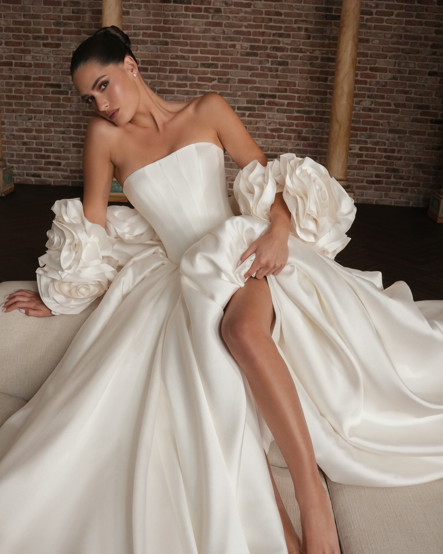 High-fashion strapless wedding dress for modern brides, made with structured corset and flowing satin fabric