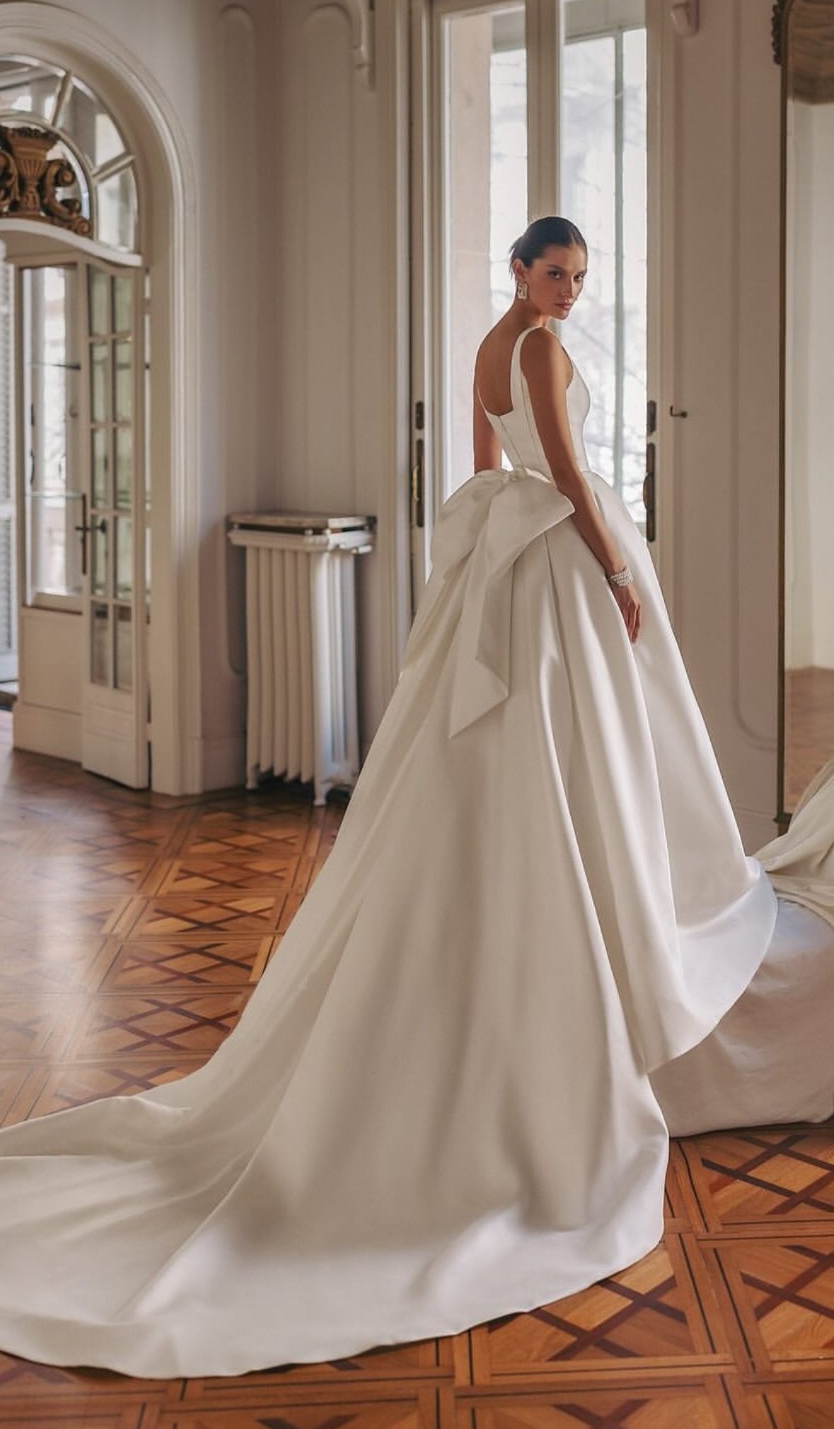 Minimalist satin bridal gown with sleeveless top and tailored silhouette