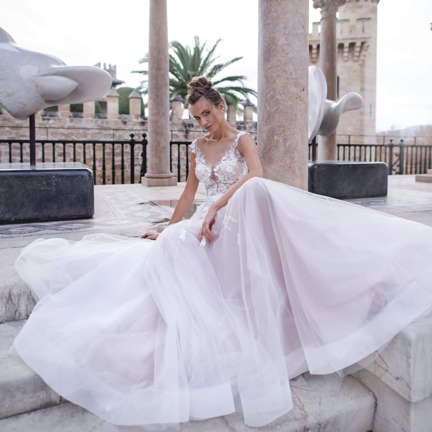 Back view of custom blush wedding dress with light train