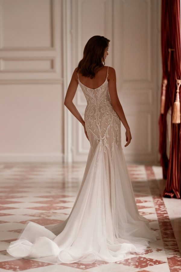 Side view showing curve-enhancing mermaid cut and modern romantic lace appliqué.