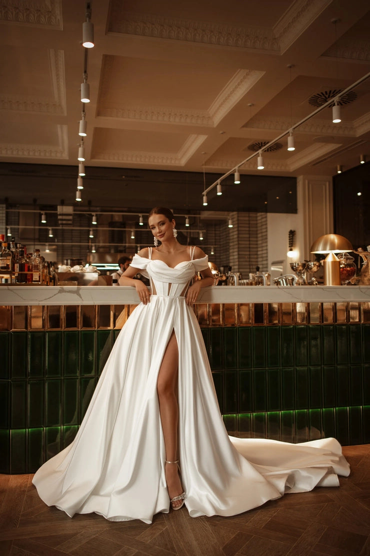 Satin bridal gown with layered train and open back, ideal for luxury weddings.
