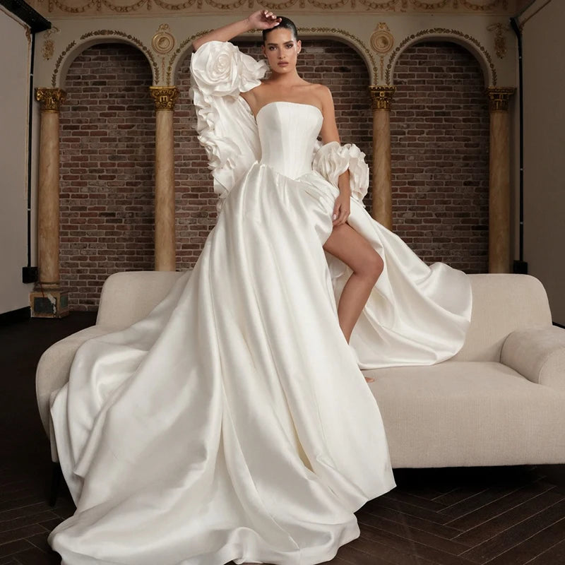 Elegant A-line wedding dress with strapless corset bodice and 3D flower sleeves made from premium satin, featuring a dramatic sweep train.