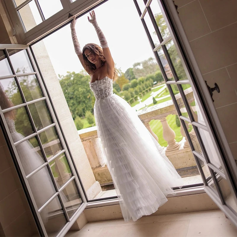Strapless ruffled tulle A-line wedding dress with lace corset bodice