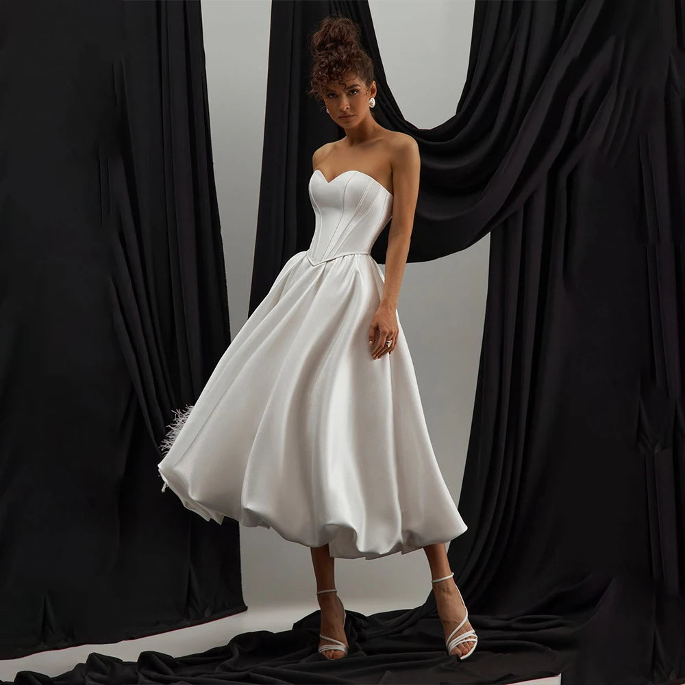 Elegant tea-length satin wedding dress with structured corset bodice and sweetheart neckline