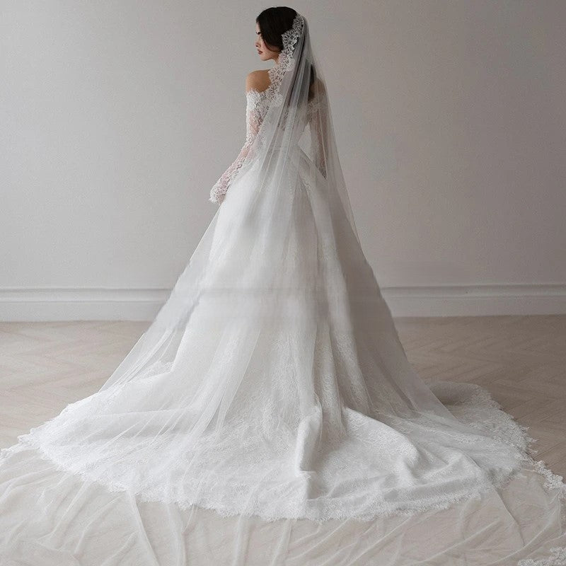 Classic ball gown wedding dress featuring fitted lace sleeves and romantic shape