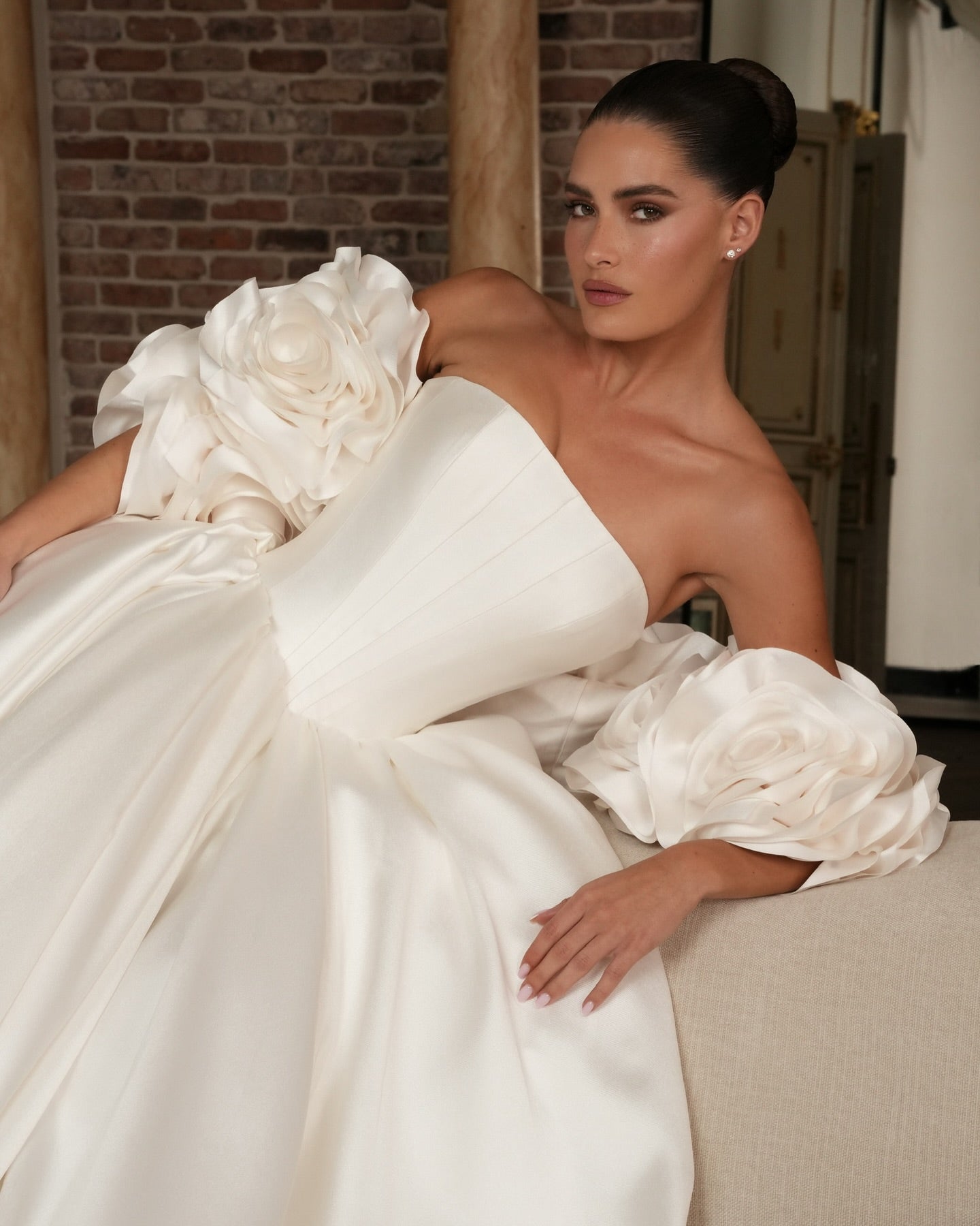 High-fashion strapless wedding dress for modern brides, made with structured corset and flowing satin fabric.