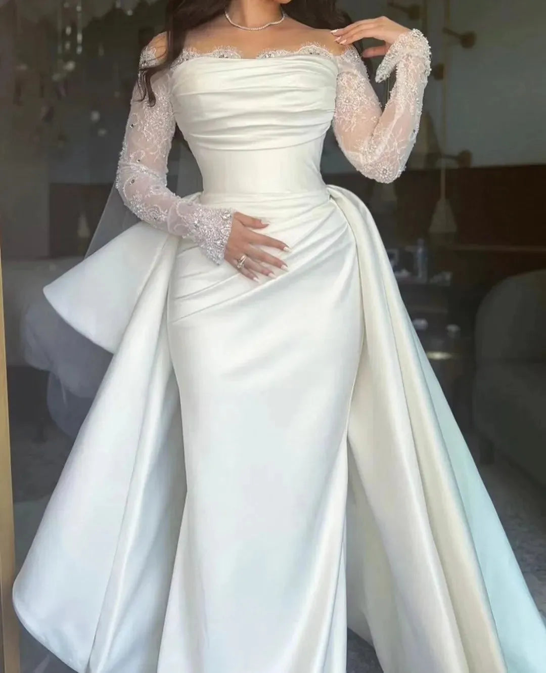 Mermaid wedding gown with draped bodice and satin side train overlay for couture-inspired style.


