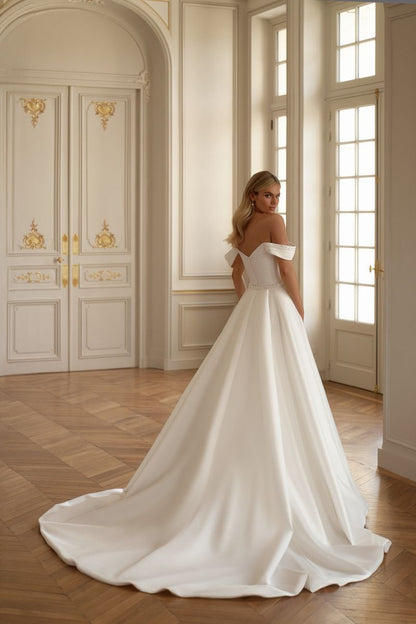 Elegant satin wedding gown with pleated beaded bodice and off-shoulder sleeves for a refined look.

