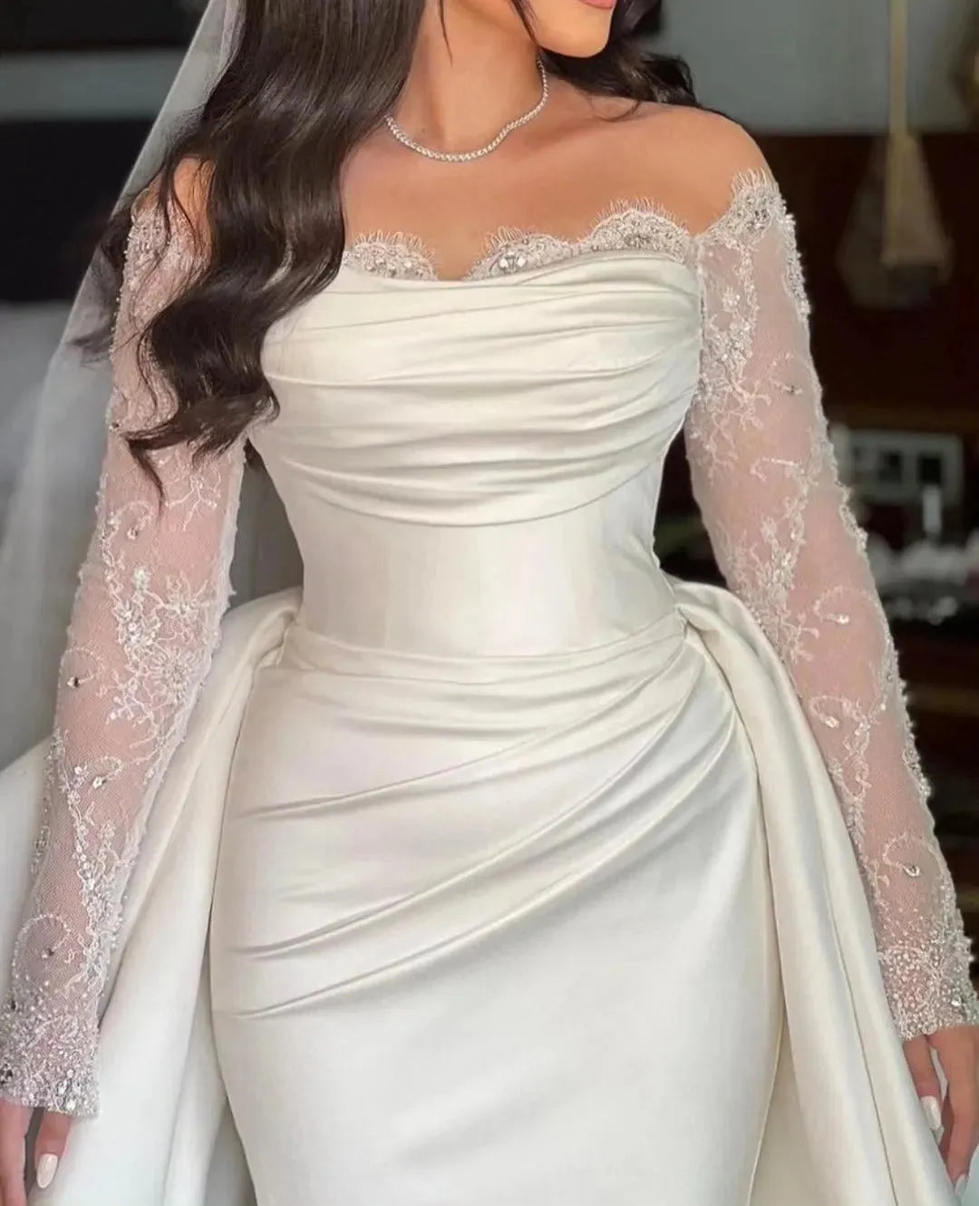 Long sleeve wedding dress in satin and lace combination, ideal for classic bridal elegance.

