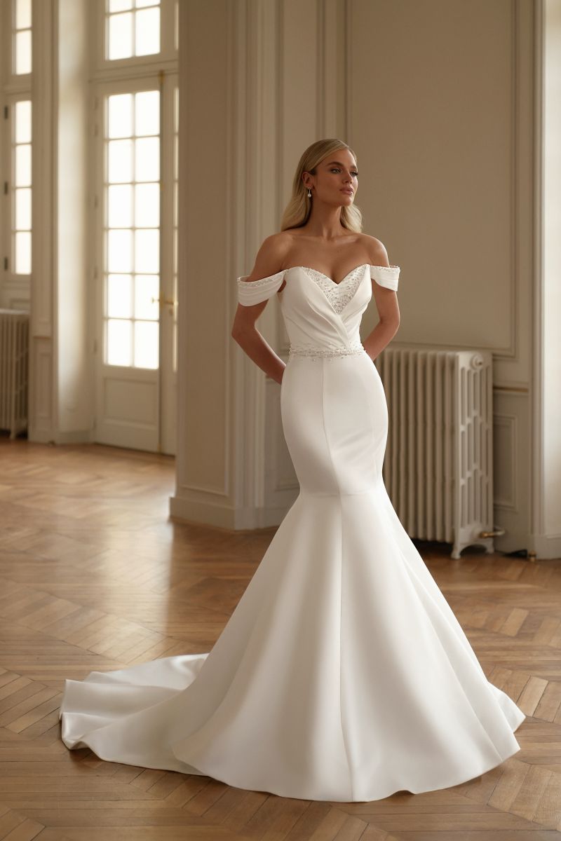 Two-in-one satin wedding dress in mermaid silhouette with off-shoulder drape and structured bodice.

