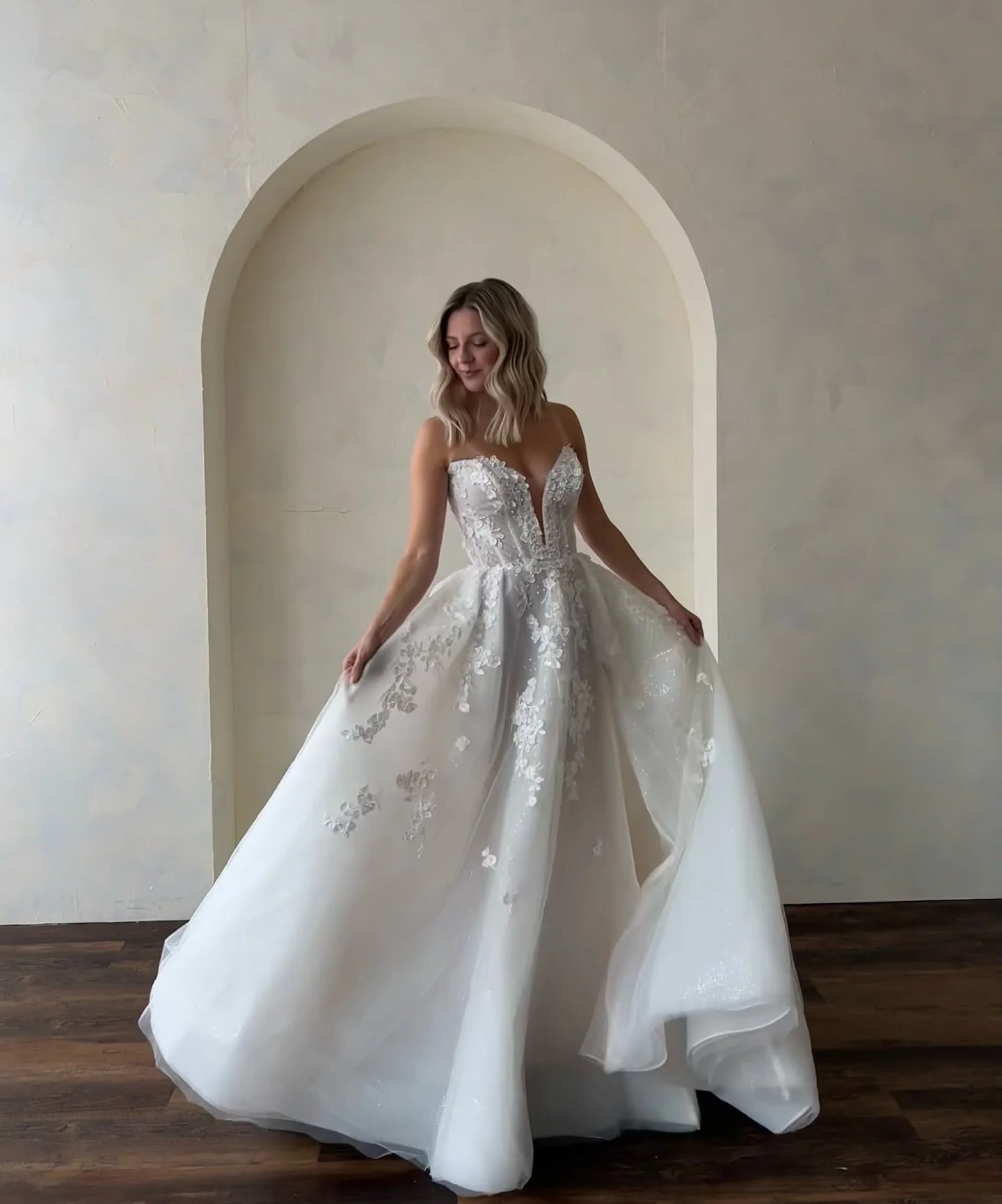 A-line wedding gown with glitter overlay and floral lace motifs, crafted for a soft yet striking bridal look.
