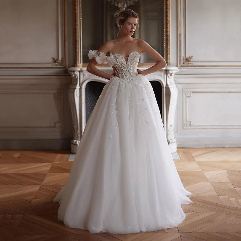 Elegant wedding dress with 3D floral appliqué and beaded illusion bustier