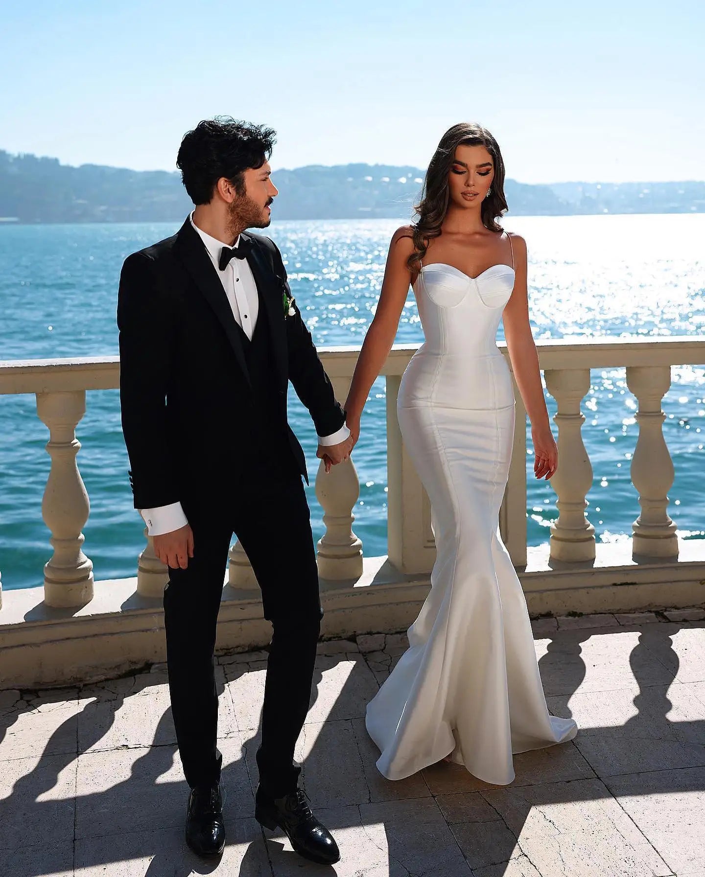 Back view of 2-in-1 wedding dress with removable long cape and cathedral-length train.

