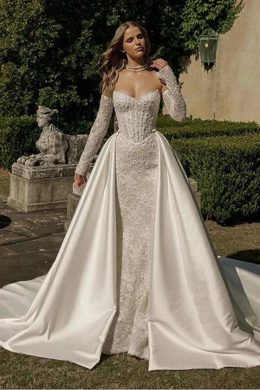 Elegant mermaid wedding dress with sweetheart neckline, lace long sleeves, and shimmering appliqué for brides seeking luxury couture.
