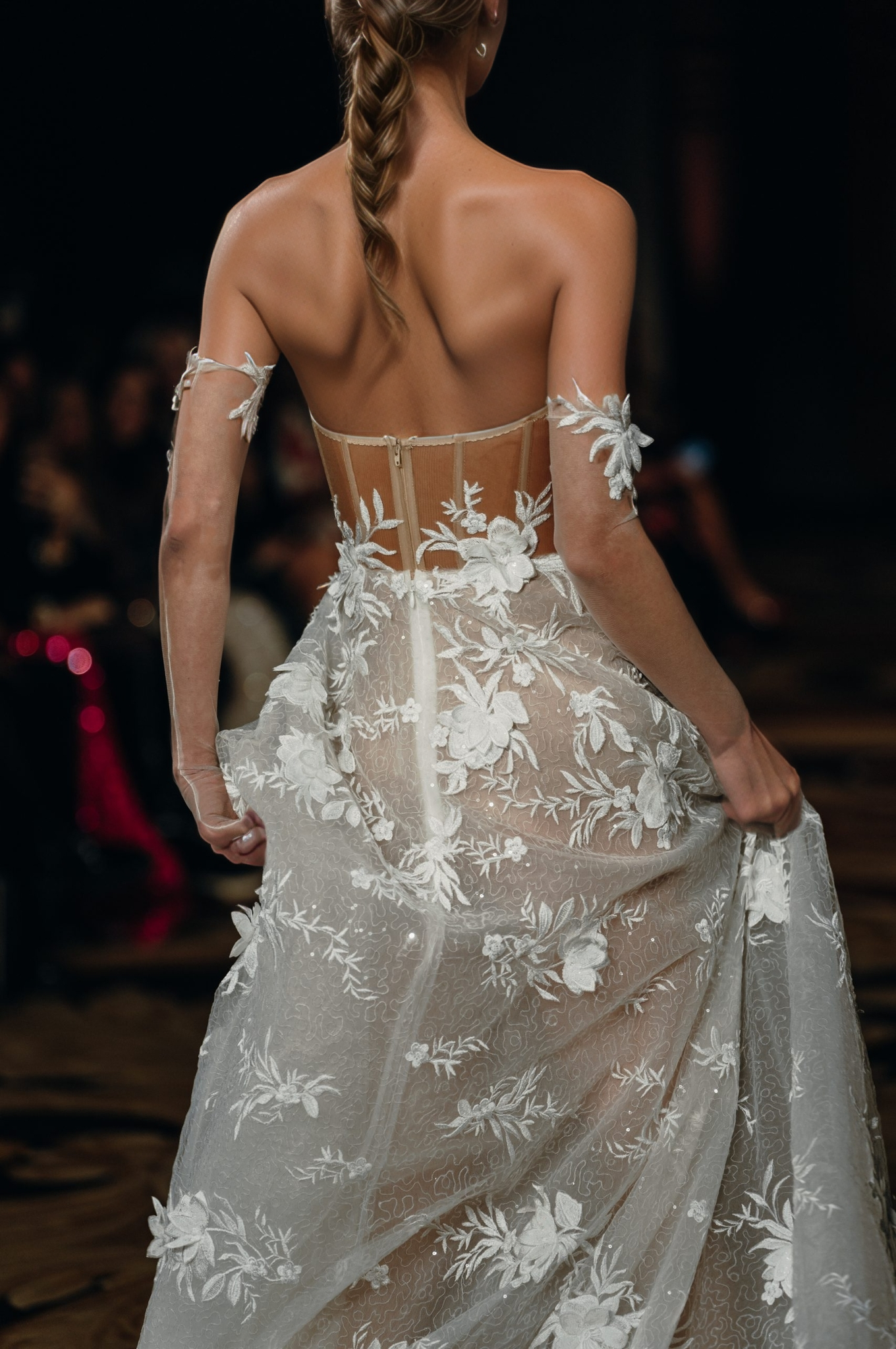 Romantic sheer wedding dress with a structured corset top and detachable off-the-shoulder sleeves.