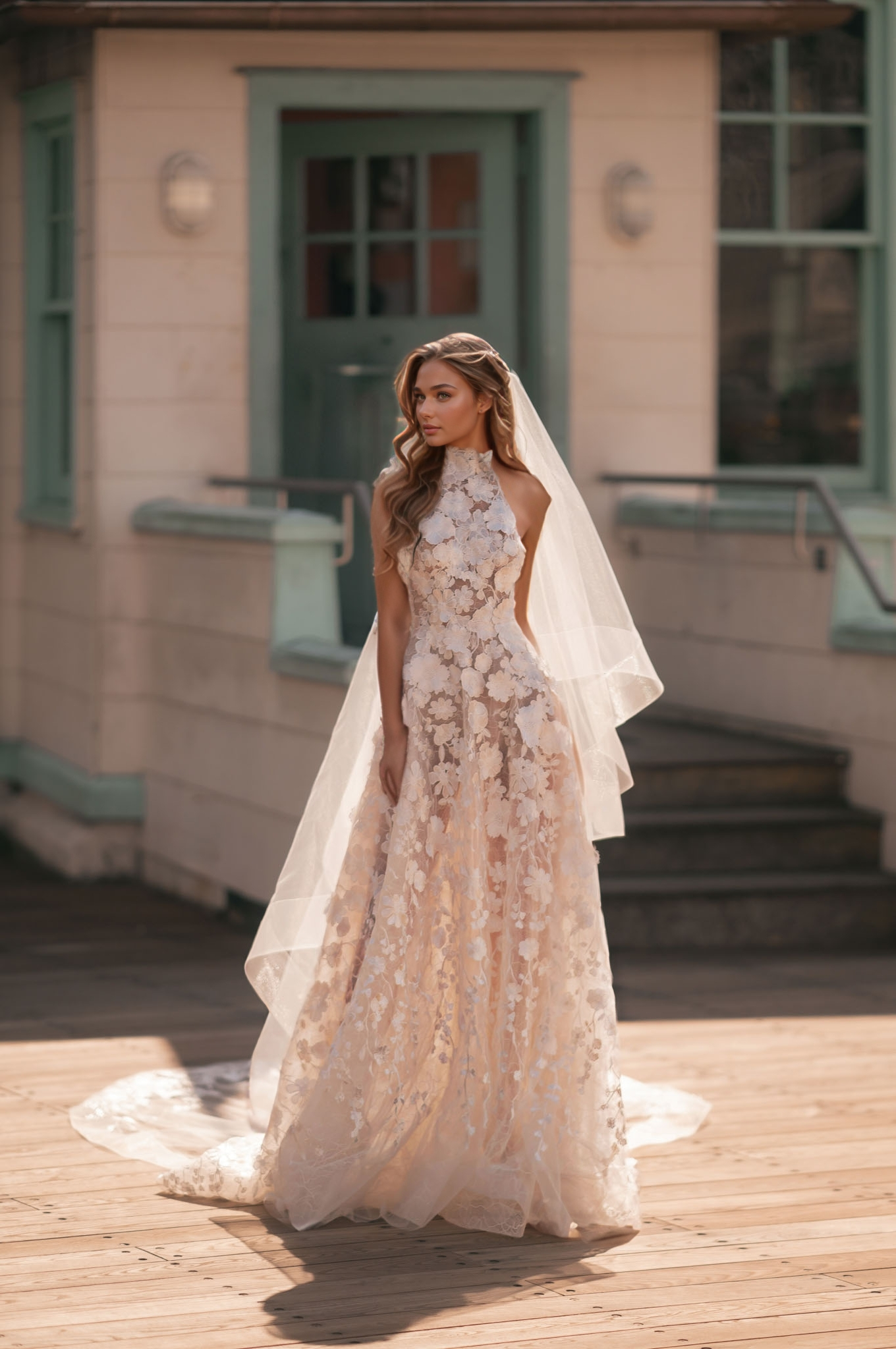 Floral 3D appliqué halter A-line wedding dress with a sheer bodice and flowing train.