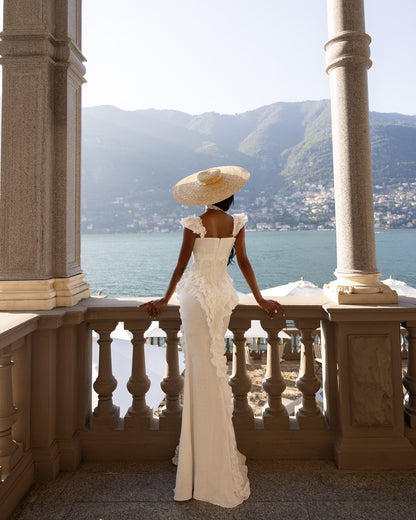Back view of custom mermaid wedding dress with lace appliqué and dramatic ruffle trim
