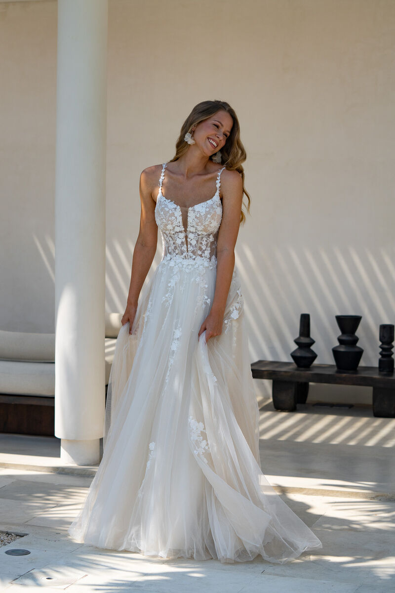 Illusion lace corset bodice with plunging neckline and floral appliqués for a modern romantic bride.