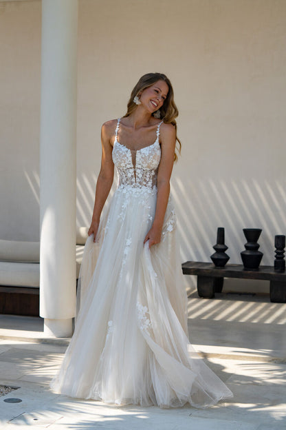 Illusion lace corset bodice with plunging neckline and floral appliqués for a modern romantic bride.