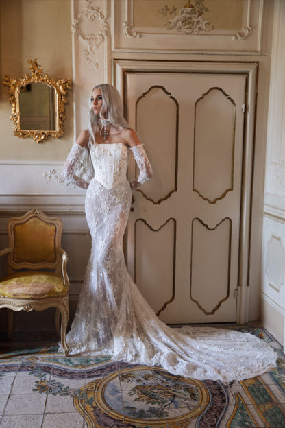 Elegant back view of corset bridal gown with sculpted lace and dramatic chapel train.