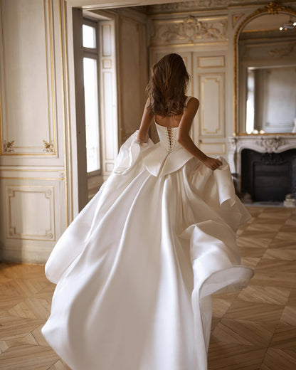 Sleek and modern wedding dress in ivory satin for luxury ceremonies