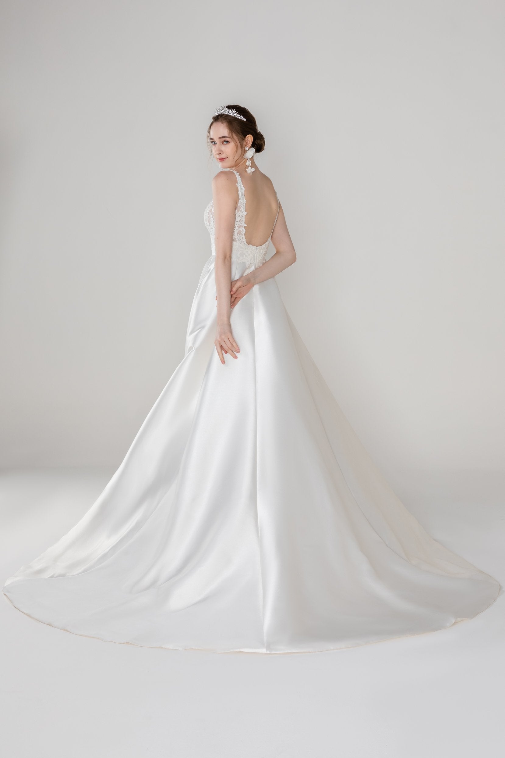 Modern minimalist bridal style with satin A-line gown, open back and clean lines for effortless wedding day grace.