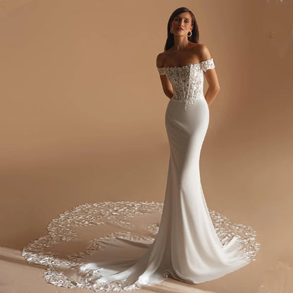 Elegant mermaid wedding dress with off-shoulder lace bodice, crepe skirt and floral sweep train for modern brides.