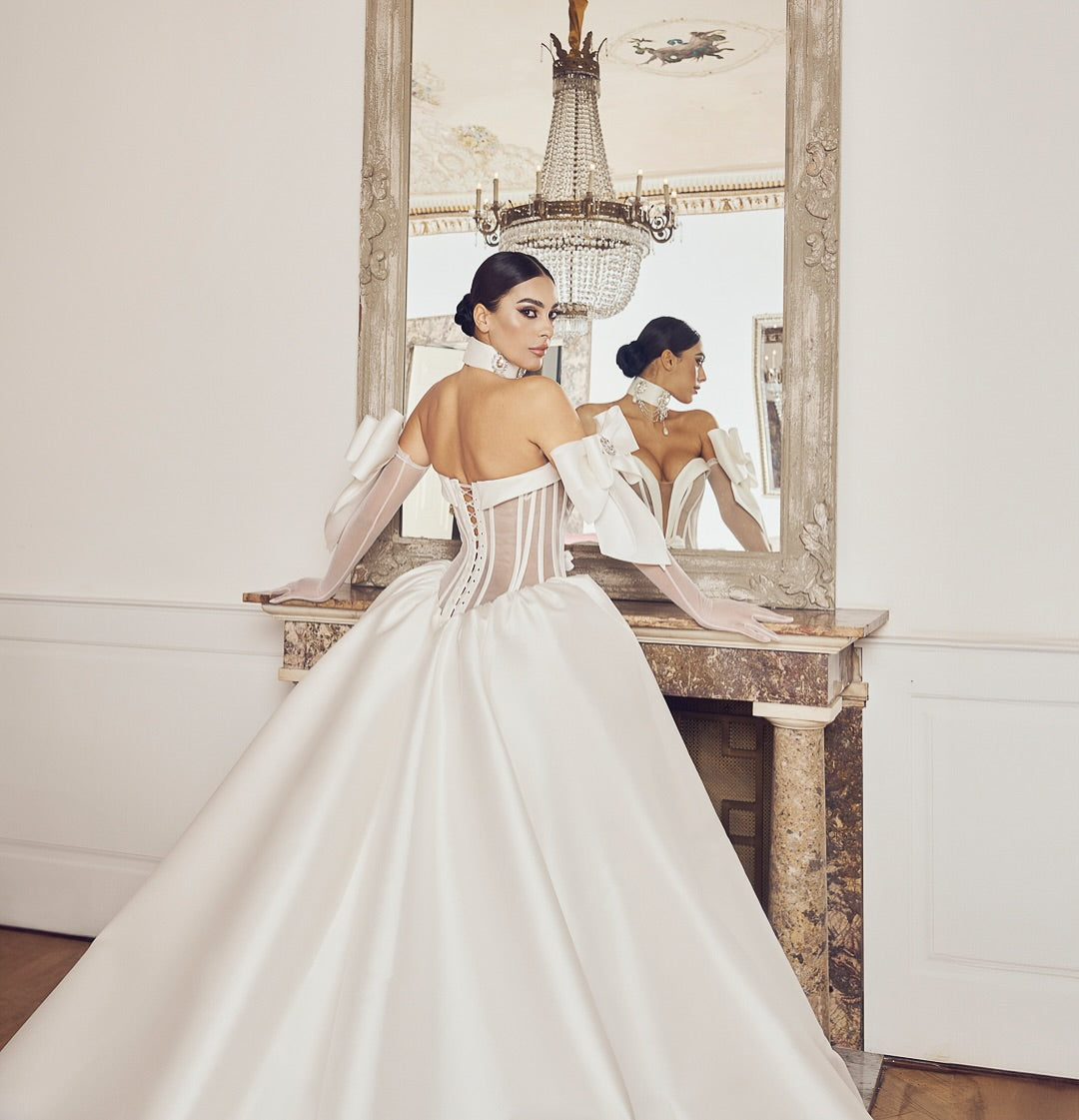 Custom princess bridal gown with center bow and illusion top