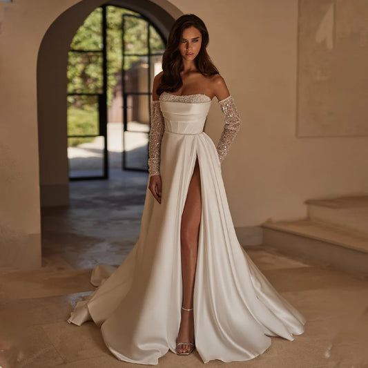 Elegant satin A-line wedding dress with detachable beaded long sleeves and pleated bodice.