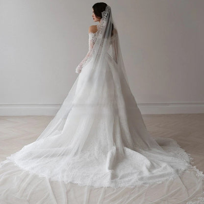 Classic ball gown wedding dress featuring fitted lace sleeves and romantic shape