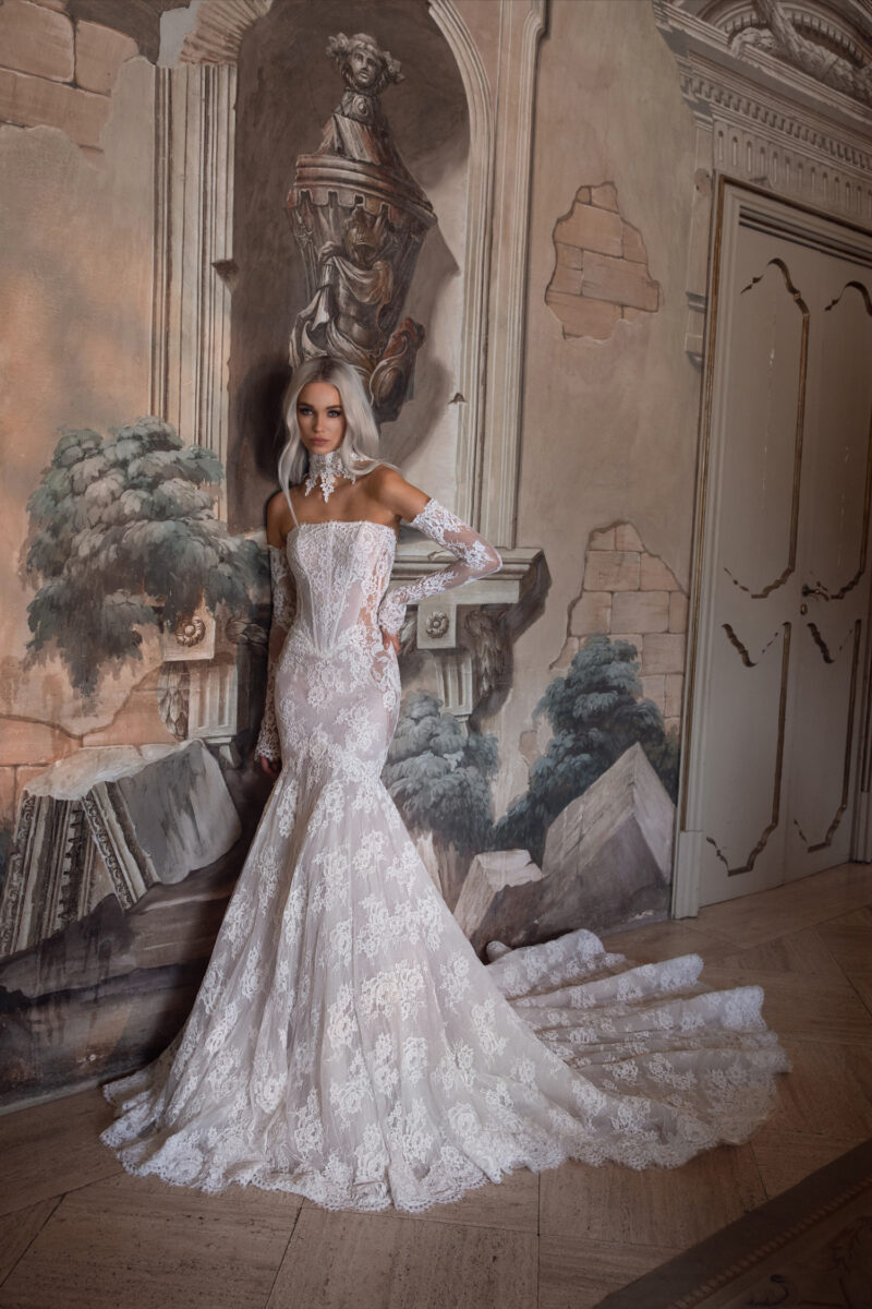 Bride wearing mermaid lace gown with long cathedral train