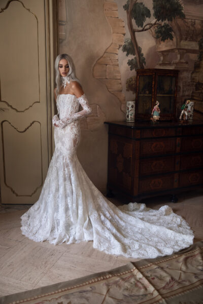 Close-up of lace mermaid bridal gown with strapless corset and gloves
