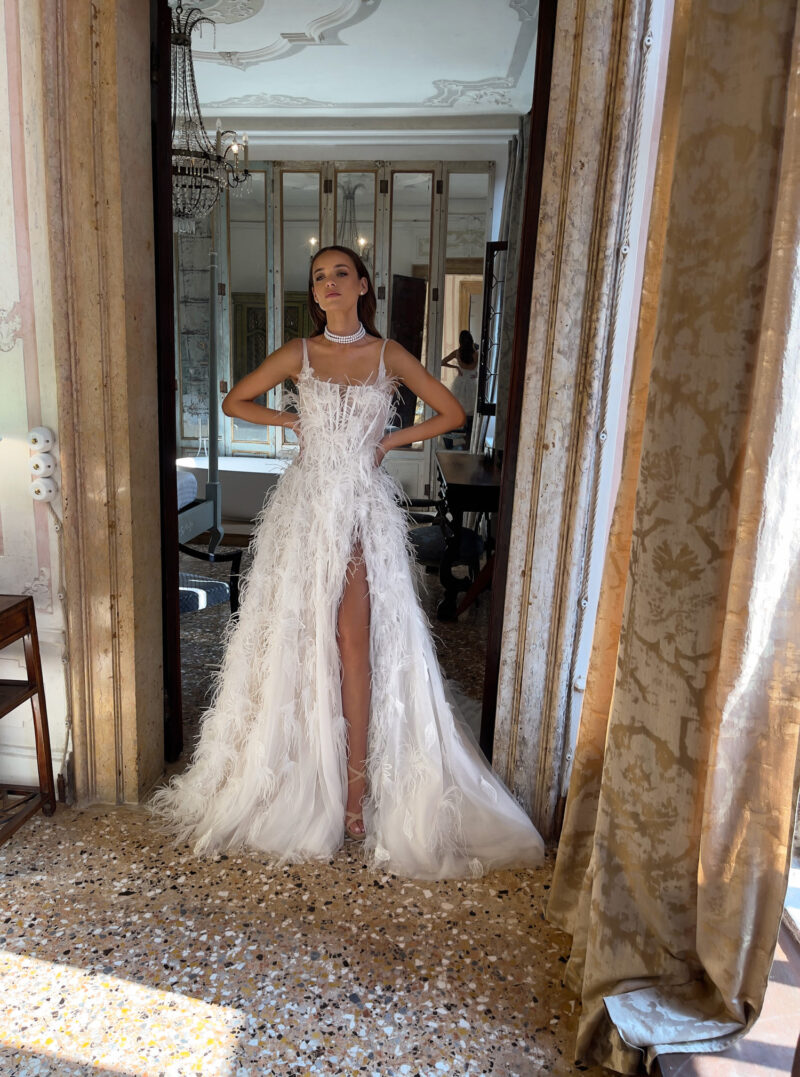 Side slit detail on feather embellished tulle wedding dress