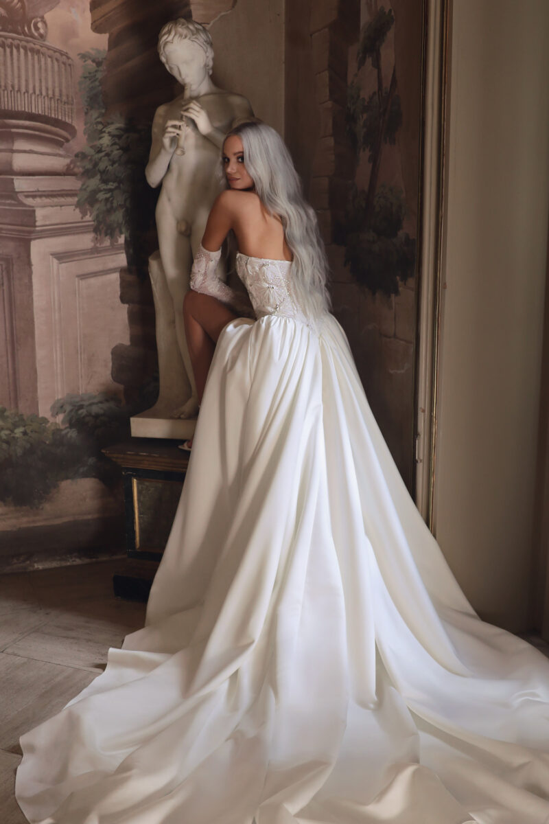 Back view of satin wedding dress with long train