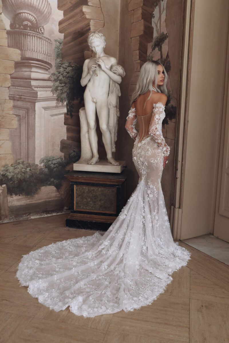 Back view of sheer lace mermaid gown with long train